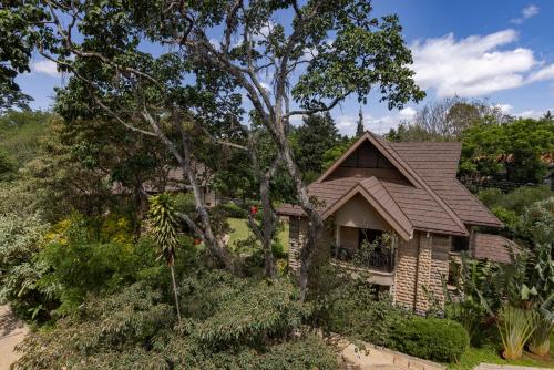 a house with a brown roof and some trees at Hermosa Garden Hotel in Nairobi