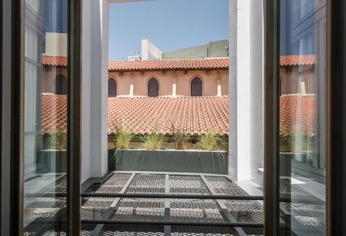 an open window with a view of a building at Vegga Suites in Heraklio Town