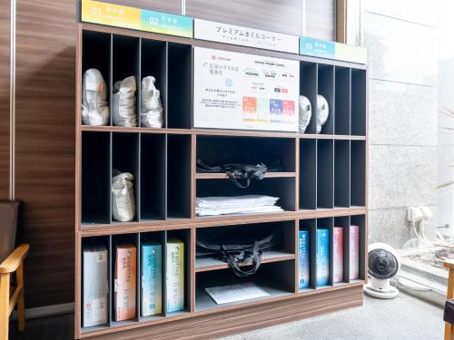 a book shelf filled with books in a room at Tabist Urban Stays Asakusa in Tokyo