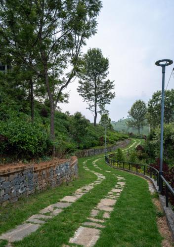 a stone path in a park with a street light at LohonoStays Villa Amani 8A in Coonoor