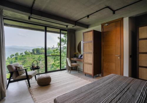 a bedroom with a bed and a desk and a window at LohonoStays Villa Amani 8A in Coonoor