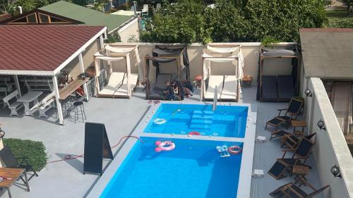 an overhead view of a swimming pool with chairs and a tent at Family Hotel Malibu in Chernomorets