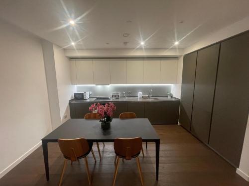 a dining room with a table and chairs in a kitchen at Busco Properties in London