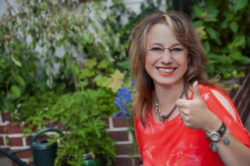 a woman giving a thumbs up while wearing glasses at Antjes Schmankerlhotel und Restaurant in Tröstau