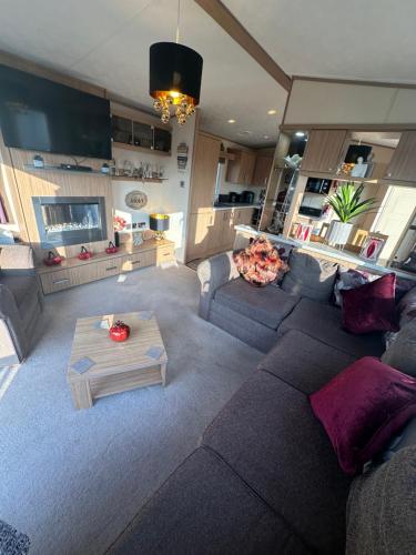 a living room with a couch and a table at 8 berth Waterside Ingoldmells Santanavan 8 C22 in Ingoldmells