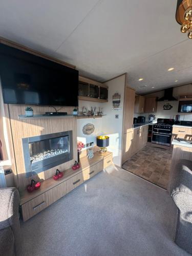 a living room with a flat screen tv and a fireplace at 8 berth Waterside Ingoldmells Santanavan 8 C22 in Ingoldmells