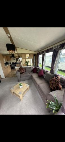 a living room with a couch and a coffee table at 8 berth Waterside Ingoldmells Santanavan 8 C22 in Ingoldmells