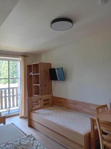 Postel nebo postele na pokoji v ubytování Apartmány u lesa