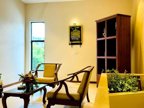 a living room with two chairs and a table at Rivorich Residence Kandy in Kandy