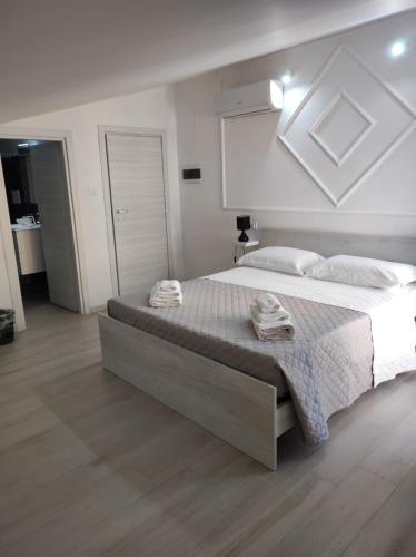 a bedroom with a large bed with towels on it at Residenza Atena Tropea in Tropea