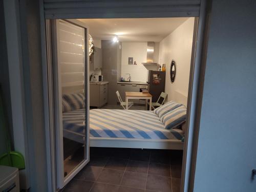 une petite chambre avec un lit et une table dans l'établissement SMV Studio, à Saint-Martin-du-Var