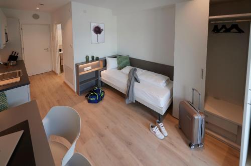a small bedroom with a bed and a desk at Ferrari Tower in Bolzano