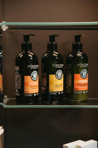 a shelf with four bottles of liquid on it at Hotel Vík í Mýrdal in Vík