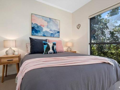 a bedroom with a large bed and a window at Wilderness House in Kulangoor
