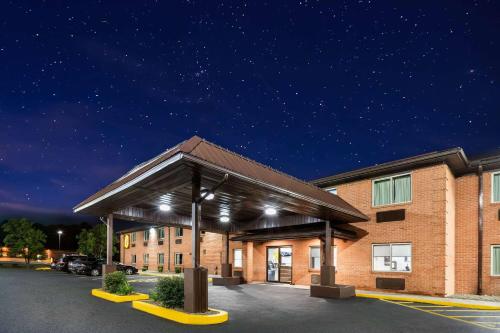 a building with a parking lot at night at Super 8 by Wyndham Fairmont in Fairmont