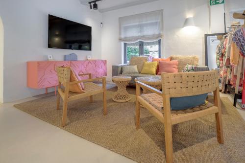 a living room with a table and chairs and a couch at Boutique Hotel Los Limoneros in Moraira