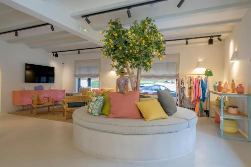 a room with a round couch with a tree in it at Boutique Hotel Los Limoneros in Moraira