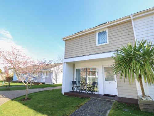 a white house with a porch with a patio at Vermont J30 in Yarmouth