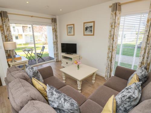 a living room with a couch and a table at Vermont J30 in Yarmouth