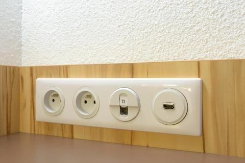 a white electrical switch on a wall at Brit Hotel Reims Croix Blandin in Reims