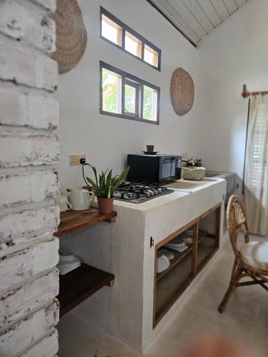 a kitchen with a counter with a stove top oven at Memo's Beach in Nilaveli