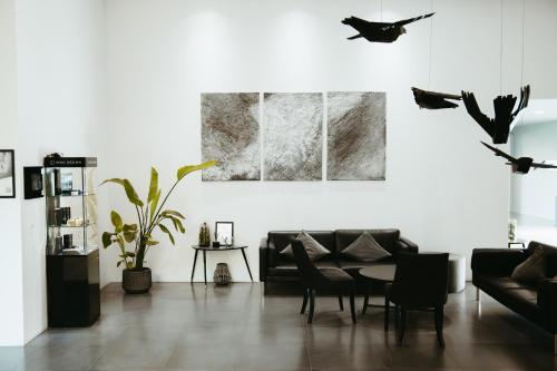 a living room with a couch and birds on the wall at Hotel Vík í Mýrdal in Vík
