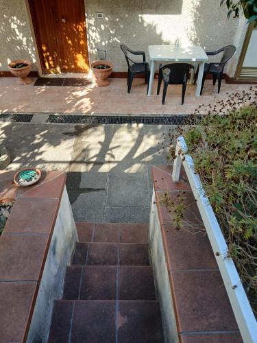 a patio with a white table and chairs and a table and chairs at Le Zagare b&b in Paola