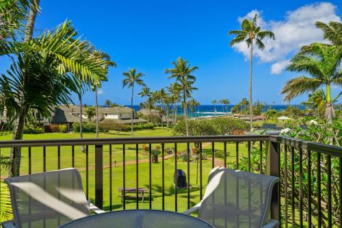 a balcony with chairs and a view of the ocean at Aston At Poipu Kai in Koloa