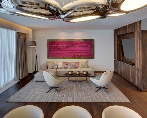 a living room with a couch and a table and chairs at Hyatt Regency Andares Guadalajara in Guadalajara
