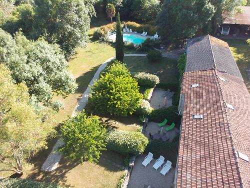 - une vue aérienne sur une maison avec un jardin et une piscine dans l'établissement Le Bois Fleuri : Ensemble de 3 gîtes avec piscine pour 18 personnes, à Saint-Crépin