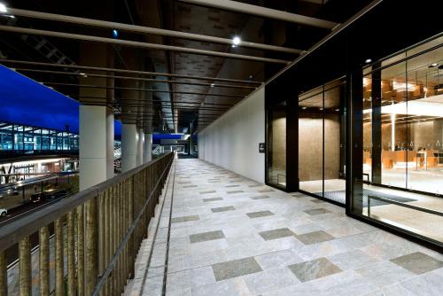 a walkway in a building with glass doors at Hilton Nagasaki in Nagasaki