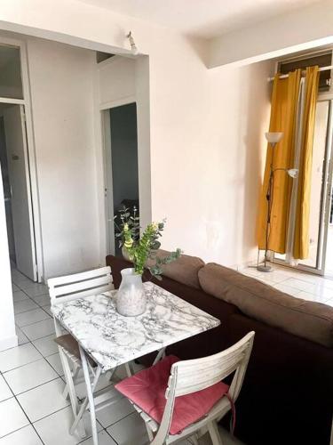 a table and chairs in a living room with a couch at Johanny Home in Les Abymes