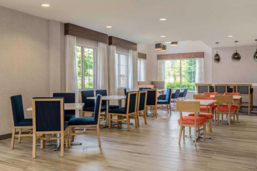 a dining room with tables and chairs and windows at Hampton Inn Manchester Downtown in Manchester