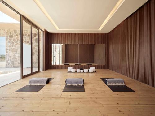 a yoga room with three mats on a wooden floor at Banyan Tree Veya, Valle de Guadalupe - A Wellbeing & Wine Resort in Valle de Guadalupe
