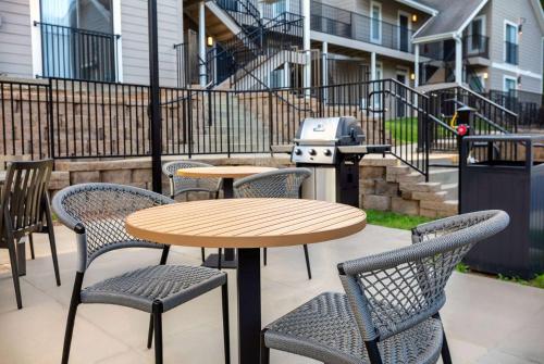a table and chairs and a grill on a patio at WaterWalk Extended Stay by Wyndham Atlanta Perimeter in Atlanta