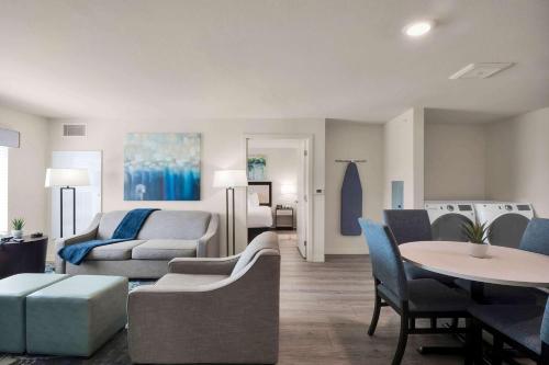 a living room with a couch and a table and chairs at WaterWalk Extended Stay by Wyndham Charlotte - Arrowood in Charlotte