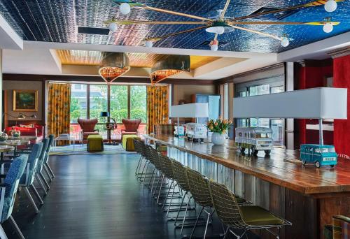 a bar in a restaurant with chairs and tables at Graduate by Hilton Madison in Madison