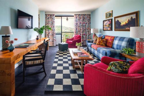 a living room with a couch and a table at Graduate by Hilton Fayetteville, AR in Fayetteville