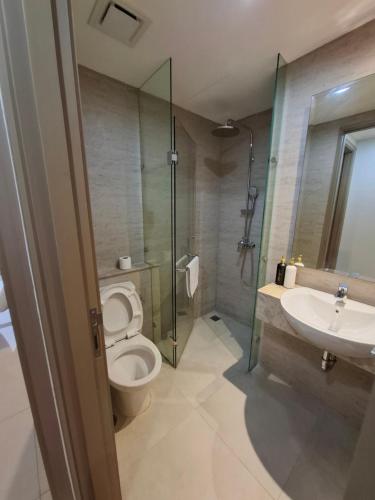 a bathroom with a toilet and a sink and a shower at New! 1 bedroom Gold coast Pik Honolulu tower in Jakarta