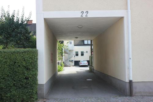 an alleyway with a car parked in a building at Stor lägenhet i centrum in Karlshamn