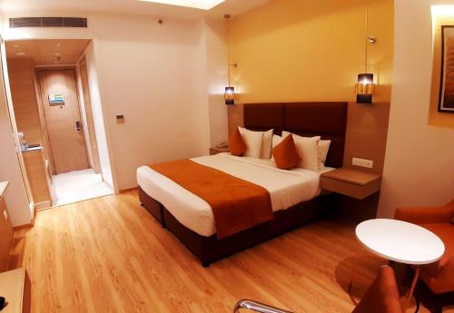a hotel room with a large bed in a room at Best Western Vrindavan in Vrindāvan