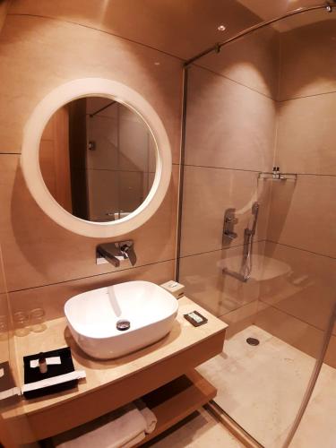 a bathroom with a sink and a shower at Best Western Vrindavan in Vrindāvan