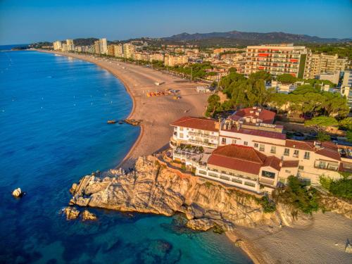 an aerial view of a beach with buildings and the ocean at Hotel Costa Brava in Platja  d'Aro