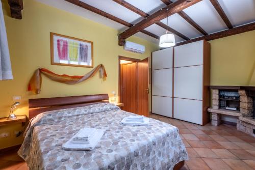 a bedroom with a bed and a fireplace at Casa Parco dell'Elsa in San Marziale