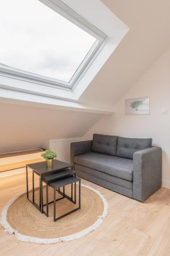 un salon avec un canapé et une table dans l'établissement Lille centre - Bel appartement sous les combles !, à Lille