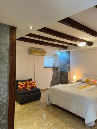 a bedroom with a bed and a couch in it at Bernarda in Skrbčići