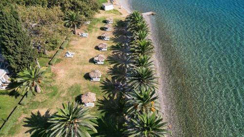 an aerial view of a beach with palm trees and tents at Long Beach Hotel & Resort in Lóngos