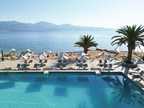 a swimming pool with chairs and a view of the ocean at Long Beach Hotel & Resort in Lóngos