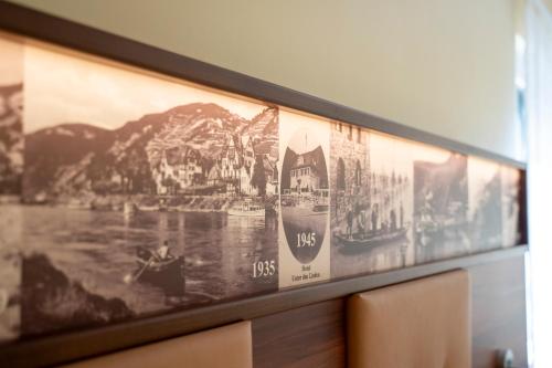a framed picture of boats on a wall at Hotel Unter den Linden in Rüdesheim am Rhein