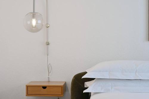a bedroom with a bed with a lamp and a night stand at Beautiful and spacious 4-Room Apartments in City Center in Wuppertal